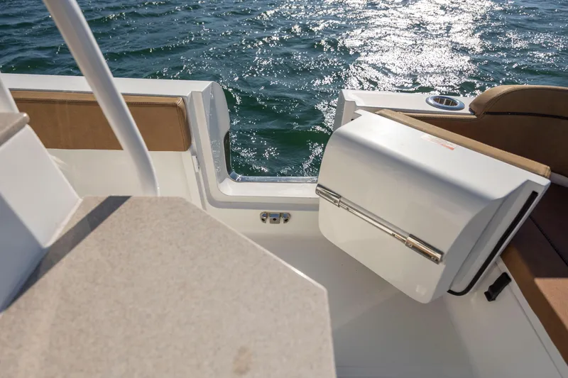 Slide: The Image of 2021 Sea Hunt Escape 27 boat interior with open hatch, overlooking sparkling water. - 12