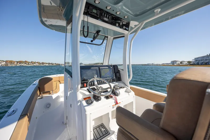 Slide: The Image of 2021 Sea Hunt Escape 27 boat interior with navigation equipment on a sunny day. - 14