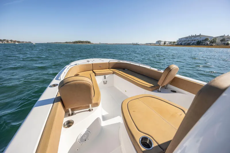 Slide: The Image of 2021 Sea Hunt Escape 27 boat with tan seating on open water. - 16