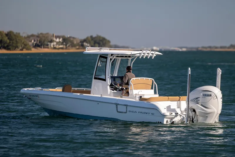 Slide: The Image of 2021 Sea Hunt Escape 27 boat cruising on a sunny day with Yamaha engine. - 2
