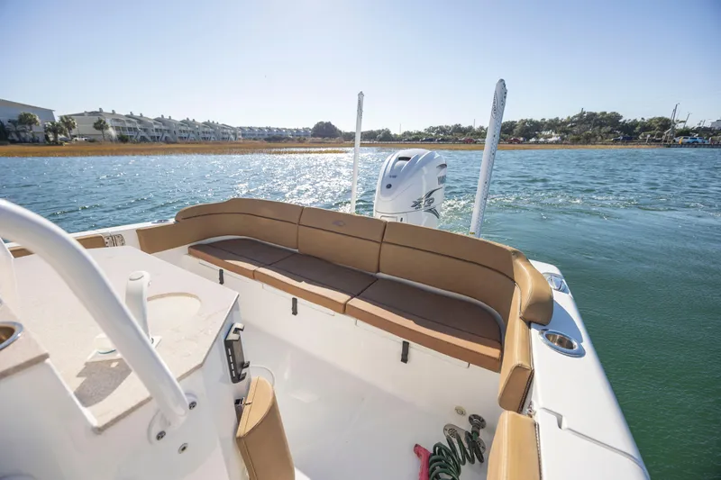 Slide: The Image of 2021 Sea Hunt Escape 27 boat interior with seating, on a sunny day. - 7