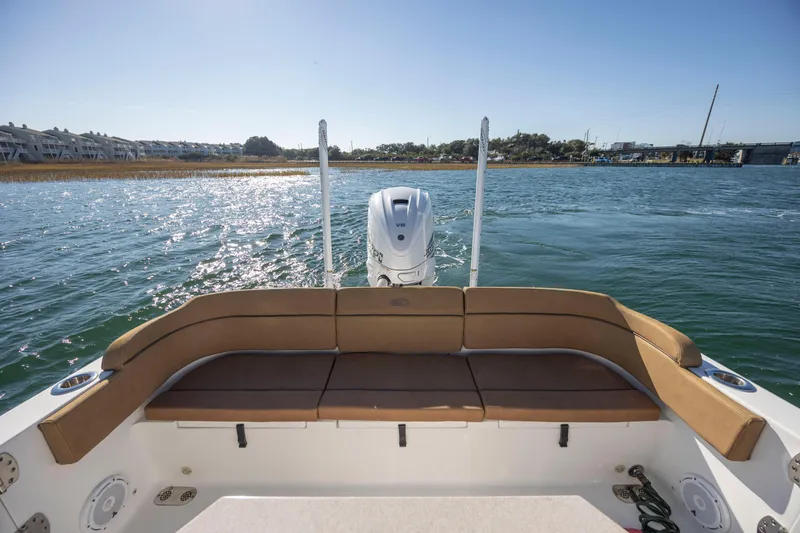 Slide: The Image of 2021 Sea Hunt Escape 27 boat with tan seating, cruising on a sunny day. - 8