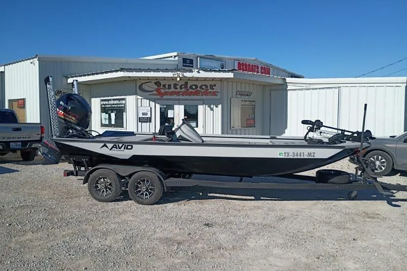 The Image of 2025 Avid 20 Rogue SC boat on trailer outside dealership. - 1