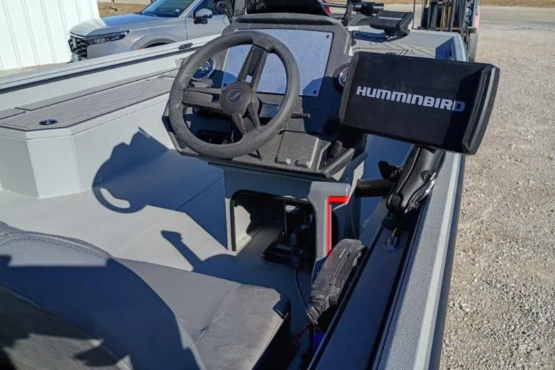 Slide: The Image of 2025 Avid 20 Rogue SC boat interior with steering wheel and Humminbird fish finder. - 3