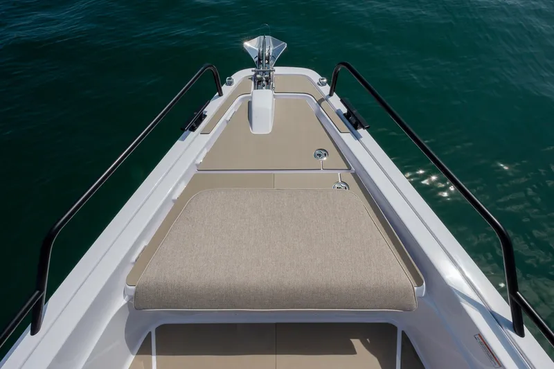 Slide: The Image of Bow view of 2026 Axopar 45 XC Cross Cabin on calm water. - 17