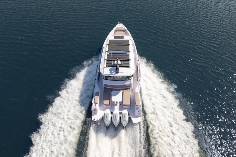 Slide: The Image of 2026 Axopar 45 XC Cross Cabin cruising on open water, aerial view. - 2