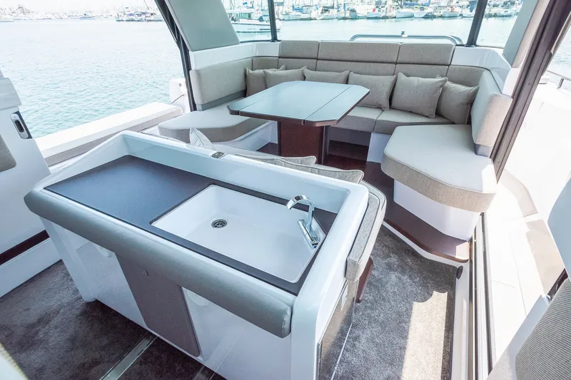 Slide: The Image of Luxurious interior of 2026 Axopar 45 XC Cross Cabin with seating and kitchenette. - 26