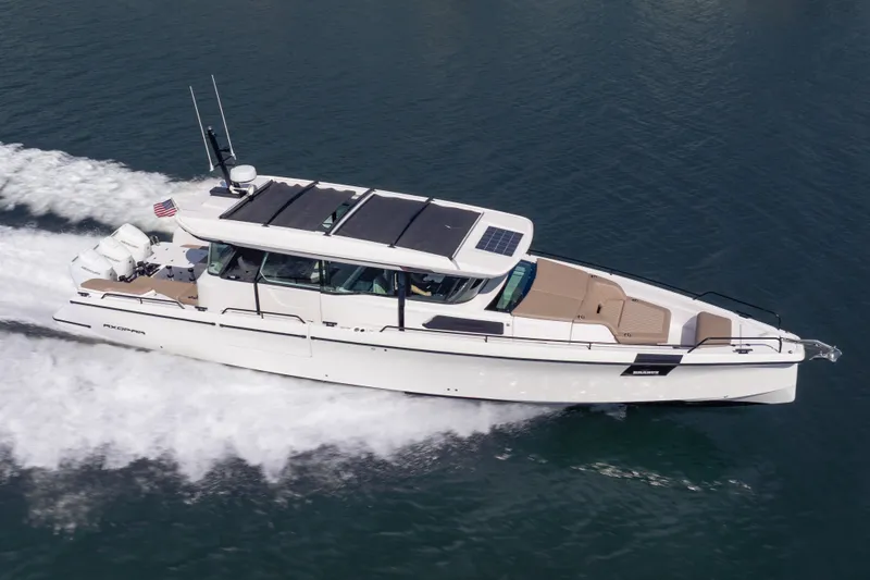 Slide: The Image of 2026 Axopar 45 XC Cross Cabin cruising on water, showcasing sleek design and powerful engines. - 3