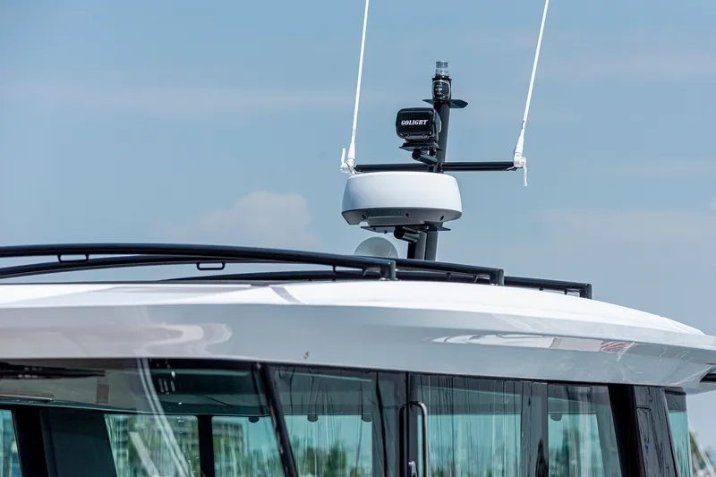Slide: The Image of Rooftop equipment on 2026 Axopar 45 XC Cross Cabin boat under clear sky. - 10