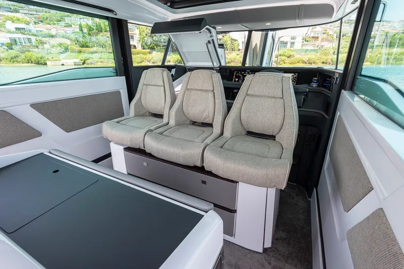 Slide: The Image of Interior of 2026 Axopar 45 XC Cross Cabin with modern seating and panoramic windows. - 21