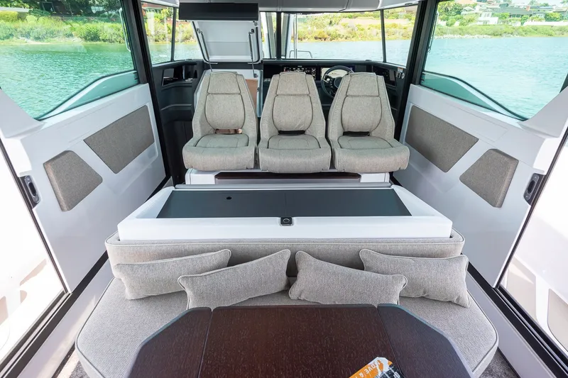Slide: The Image of Interior of 2026 Axopar 45 XC Cross Cabin with modern seating and table. - 20