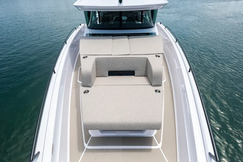 Slide: The Image of 2026 Axopar 45 XC Cross Cabin boat with spacious sun deck on calm water. - 19