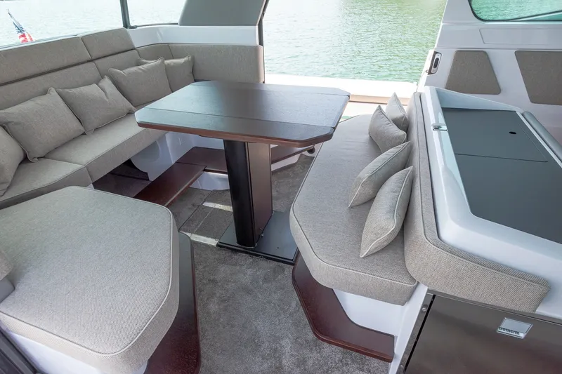 Slide: The Image of Luxurious interior of 2026 Axopar 45 XC Cross Cabin with plush seating and table. - 28