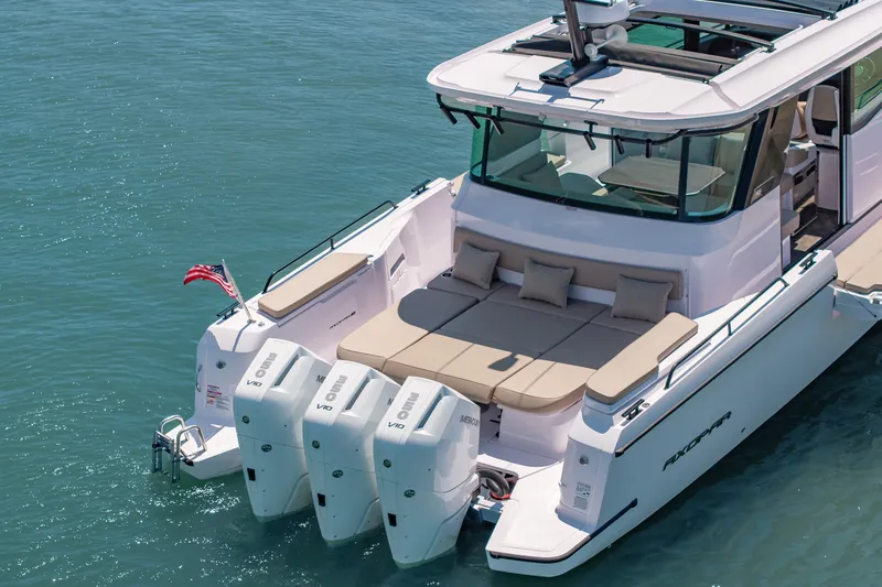 Slide: The Image of 2026 Axopar 45 XC Cross Cabin boat with triple outboard engines on calm water. - 5