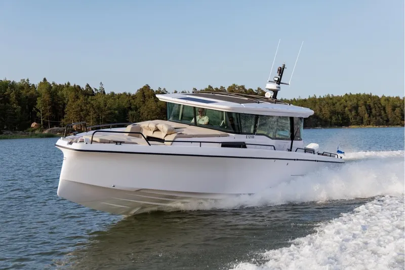 The Image of 2026 Axopar 45 XC Cross Cabin cruising on a scenic lake. - 0