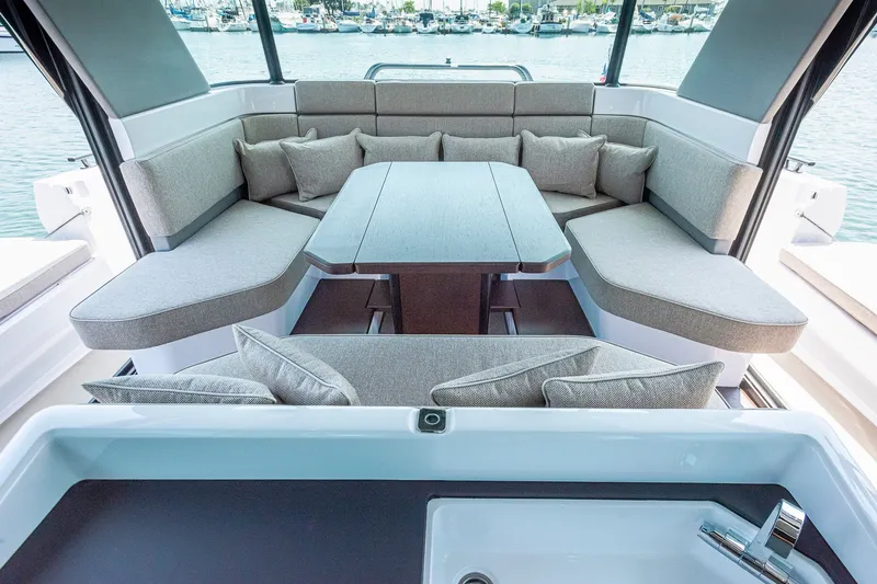 Slide: The Image of Luxurious seating area on 2026 Axopar 45 XC Cross Cabin yacht with elegant cushions. - 27
