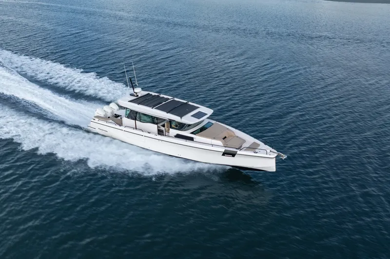 Slide: The Image of 2026 Axopar 45 XC Cross Cabin cruising on open water. - 4