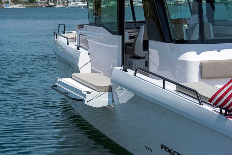 Slide: The Image of 2026 Axopar 45 XC Cross Cabin boat on water, featuring sleek design and comfortable seating. - 13