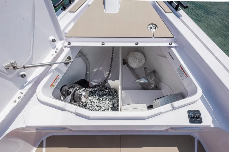 Slide: The Image of Storage compartment of 2026 Axopar 45 XC Cross Cabin with anchor and chain. - 18