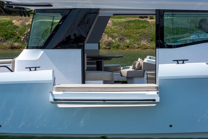 Slide: The Image of 2026 Axopar 45 XC Cross Cabin boat with open side door and luxurious interior seating. - 12