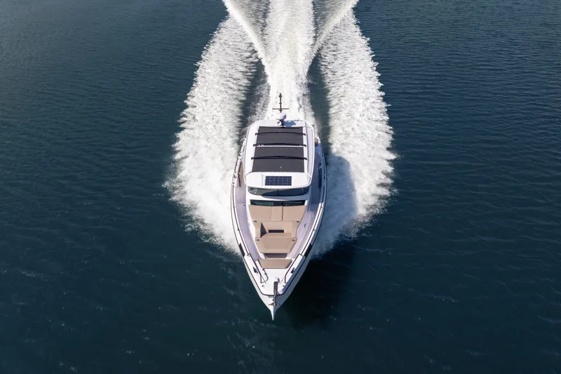 Slide: The Image of 2026 Axopar 45 XC Cross Cabin cruising on open water, aerial view. - 1
