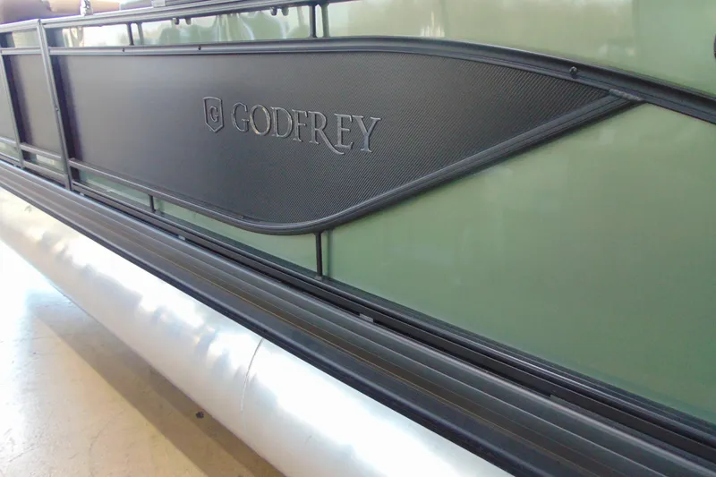 Slide: The Image of 2026 Godfrey Sweetwater 2286 DT 27" iMPACT Tri-Toon, side view with logo detail. - 3