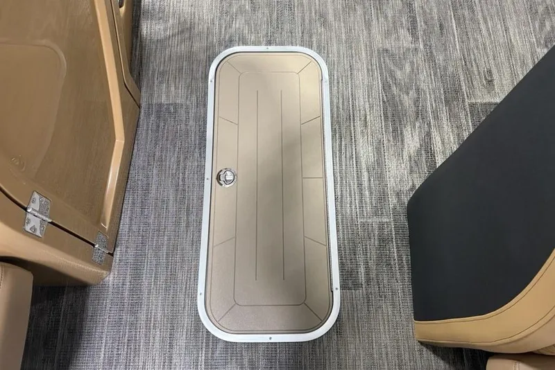 Slide: The Image of Floor hatch on 2025 Godfrey AquaPatio 235 DFL boat, surrounded by carpet and seating. - 10