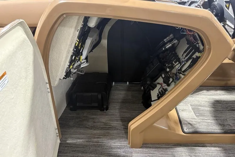Slide: The Image of Interior view of 2025 Godfrey AquaPatio 235 DFL boat, showcasing wiring and storage area. - 12