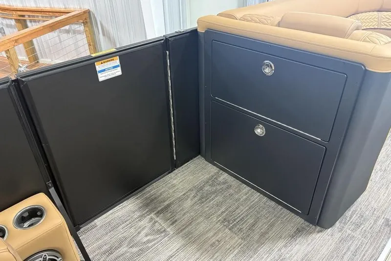 Slide: The Image of 2025 Godfrey AquaPatio 235 DFL interior with storage compartments and cup holders. - 14