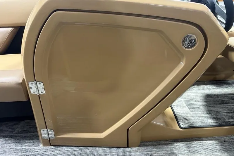 Slide: The Image of 2025 Godfrey AquaPatio 235 DFL boat interior door with tan finish and silver hinges. - 17