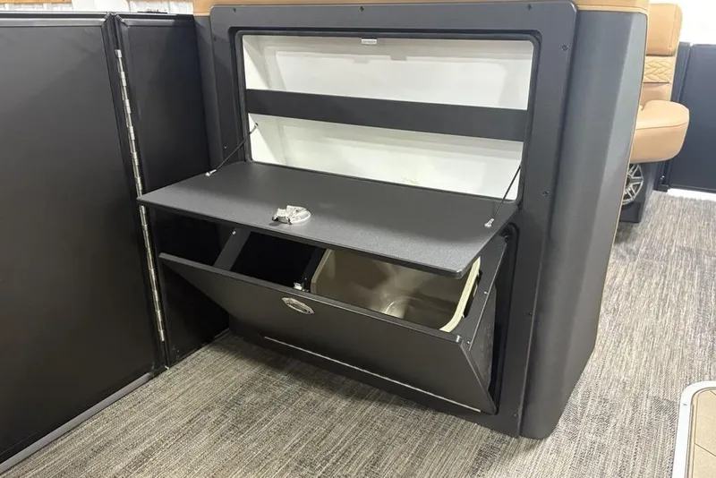 Slide: The Image of Storage compartment on 2025 Godfrey AquaPatio 235 DFL boat, featuring sleek design and functionality. - 18