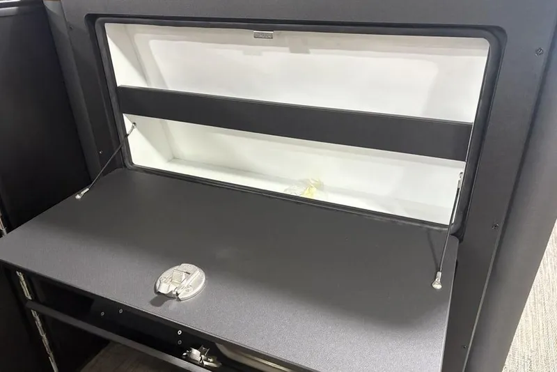 Slide: The Image of 2025 Godfrey AquaPatio 235 DFL interior storage compartment with sleek black finish. - 19