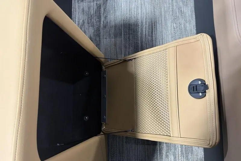 Slide: The Image of Storage compartment in 2025 Godfrey AquaPatio 235 DFL boat, featuring beige interior and latch. - 31