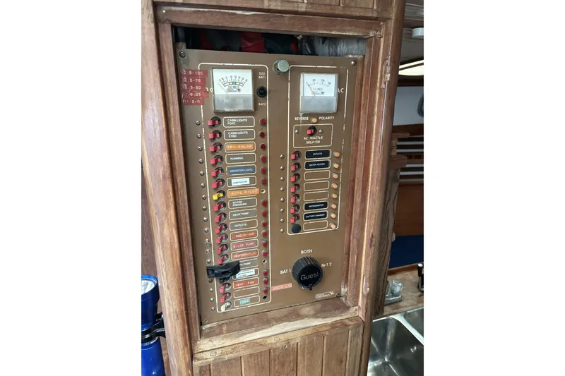 Slide: The Image of Engine compartment of a 1980 Tanton sailboat with visible wiring and components. - 10