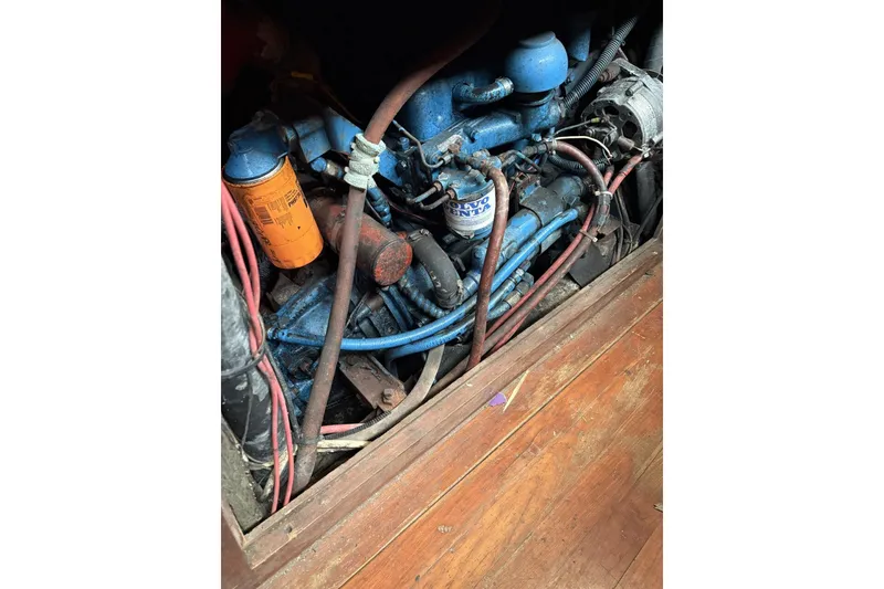 Slide: The Image of 1980 Tanton sailboat cockpit with wooden steering wheel and vintage nautical design. - 12