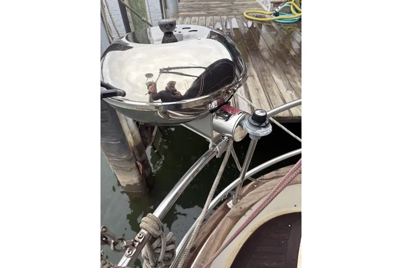 Slide: The Image of Radar equipment on a 1980 Tanton Sailboat against a cloudy sky and water backdrop. - 15