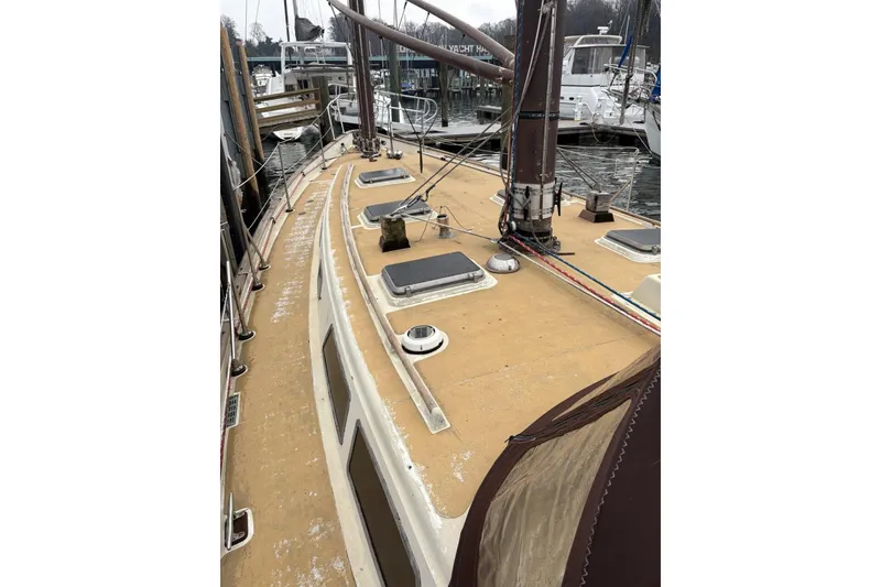 Slide: The Image of 1980 Tanton Sailboat docked, featuring a stainless steel grill and wooden deck details. - 19