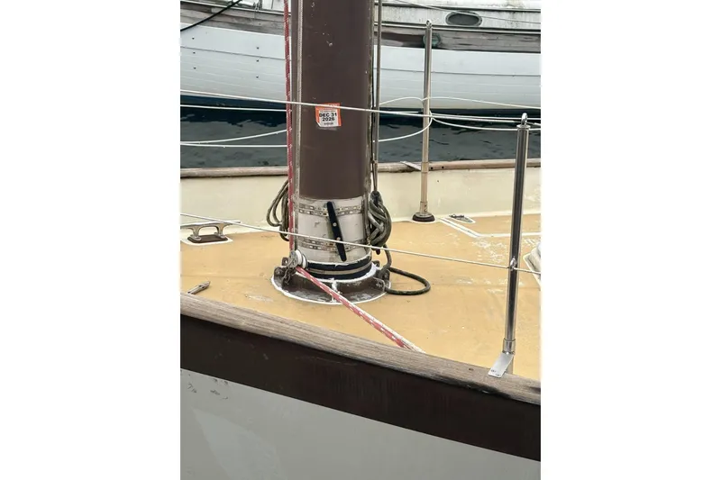 Slide: The Image of 1980 Tanton sailboat bow with anchor, docked on calm water. - 23