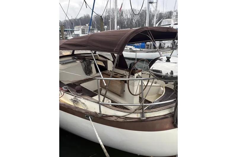 Slide: The Image of 1980 Tanton sailboat docked at marina during sunset, calm waters reflecting the vessel. - 24