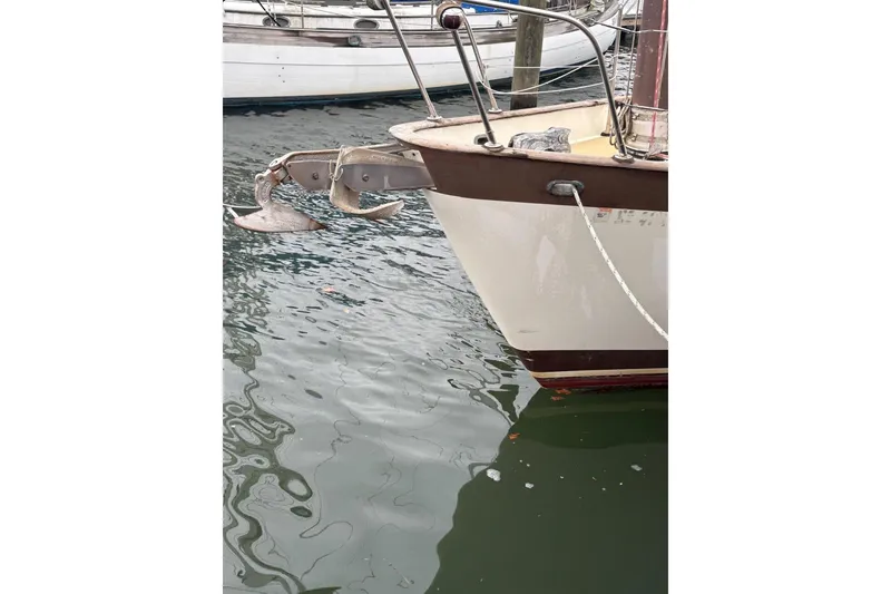 Slide: The Image of Person pressure washing a 1980 Tanton sailboat hull in a boatyard. - 25
