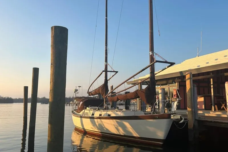 Slide: The Image of Man cleaning barnacles off 1980 Tanton sailboat hull with pressure washer. - 26