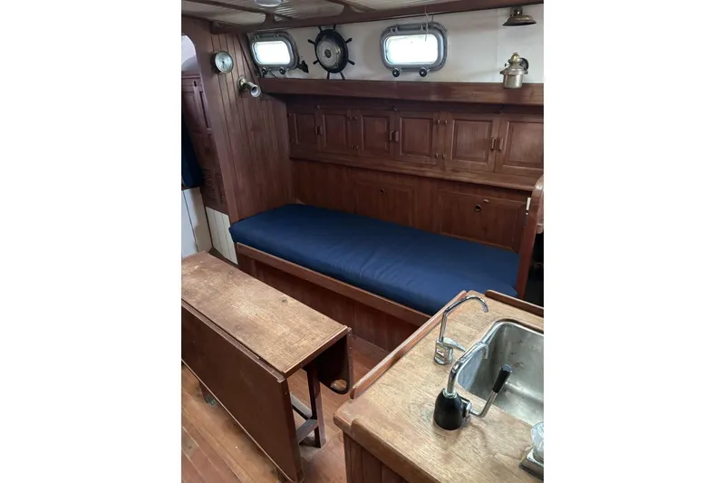 Slide: The Image of Interior of 1980 Tanton sailboat with wooden paneling, fan, and fire extinguisher. - 3