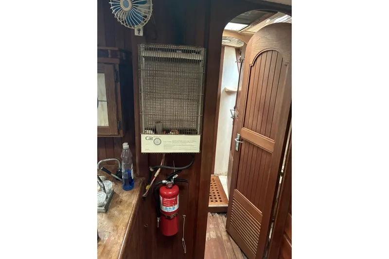 Slide: The Image of 1980 Tanton sailboat interior with wooden cabinetry and compact sink area. - 5