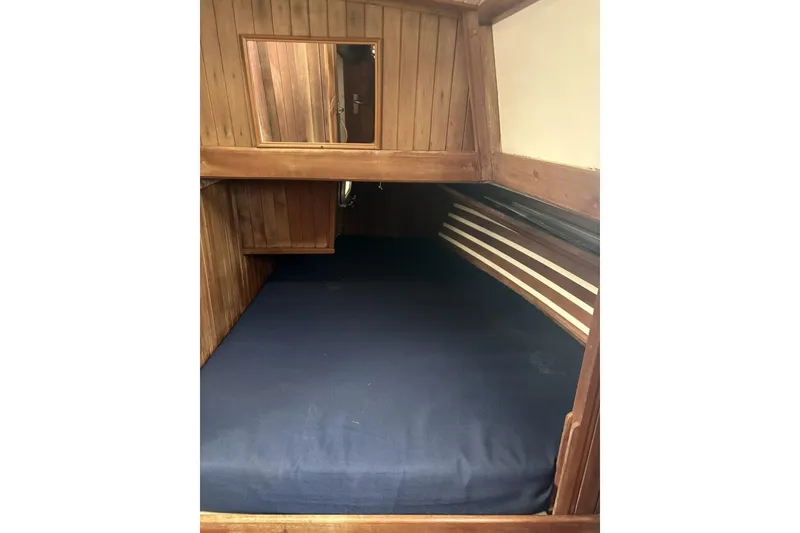 Slide: The Image of Interior of 1980 Tanton sailboat with wooden cabinetry and navigation equipment. - 7