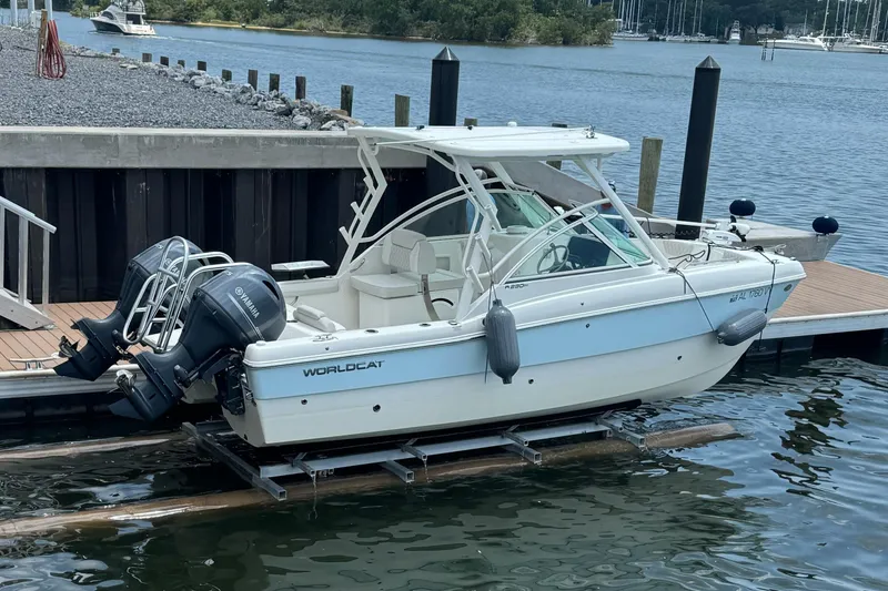 Slide: The Image of 2024 World Cat 230 DC boat docked with dual Yamaha engines. - 0