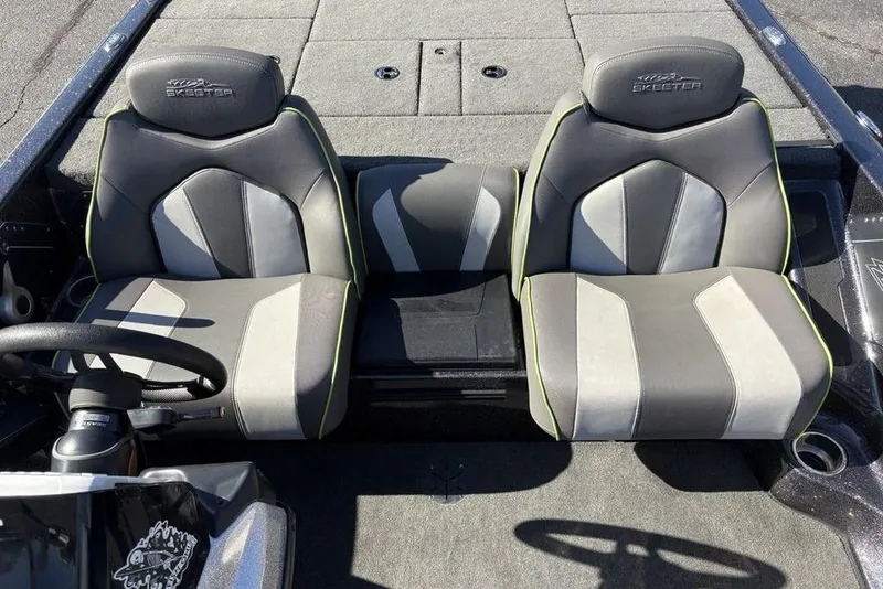 Slide: The Image of 2018 Skeeter ZX225 boat interior with dual gray seats and steering wheel. - 18