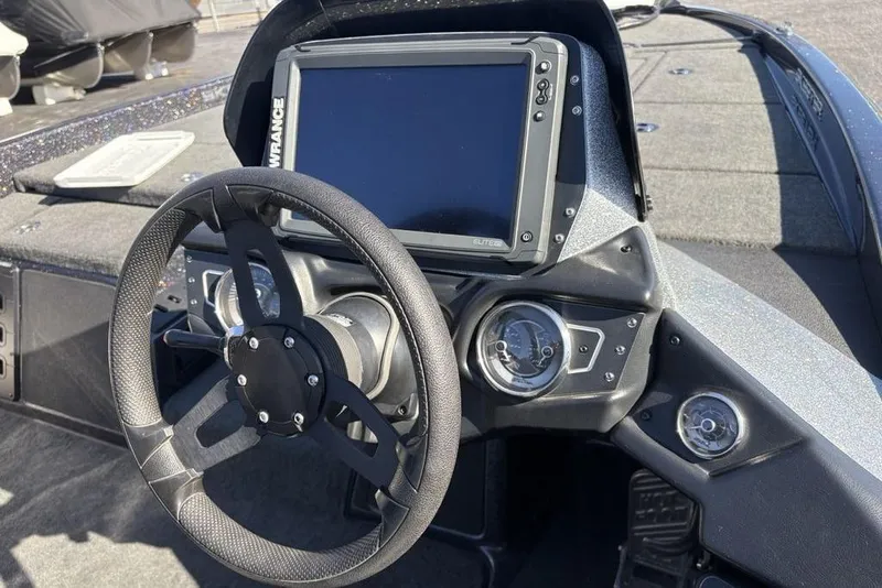 Slide: The Image of 2018 Skeeter ZX225 boat dashboard with steering wheel and navigation display. - 23