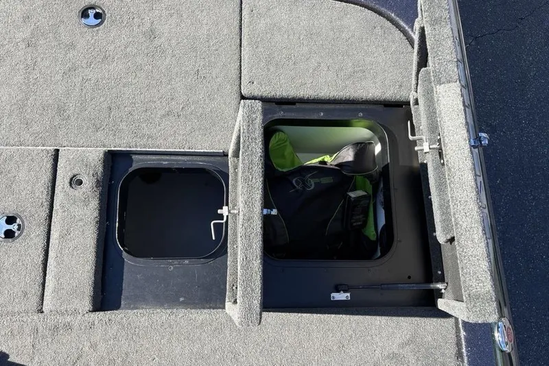 Slide: The Image of 2018 Skeeter ZX225 boat storage compartments with open hatches, revealing interior space. - 26