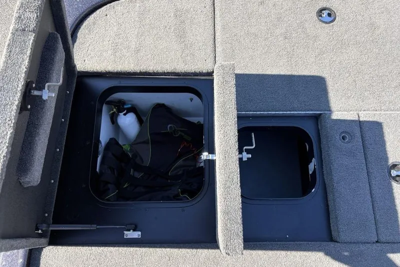 Slide: The Image of 2018 Skeeter ZX225 storage compartments with gear and equipment inside. - 27