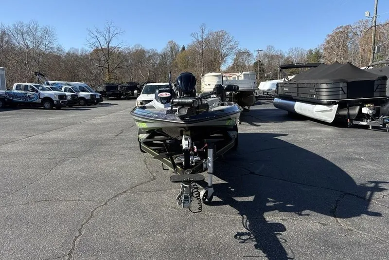 Slide: The Image of 2018 Skeeter ZX225 boat parked in a lot with other vehicles and boats. - 5